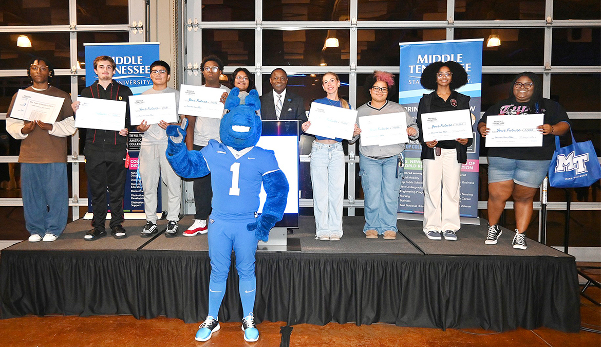 Middle Tennessee State University President Sidney A. McPhee, center, stands with the lucky winners in the scholarship drawings at the Murfreesboro, Tenn., university’s True Blue Tour recruitment stop for prospective students held Monday, Sept. 23, at the Wilma Rudolph Event Center in Clarksville, Tenn. (MTSU photo by Andrew Oppmann)