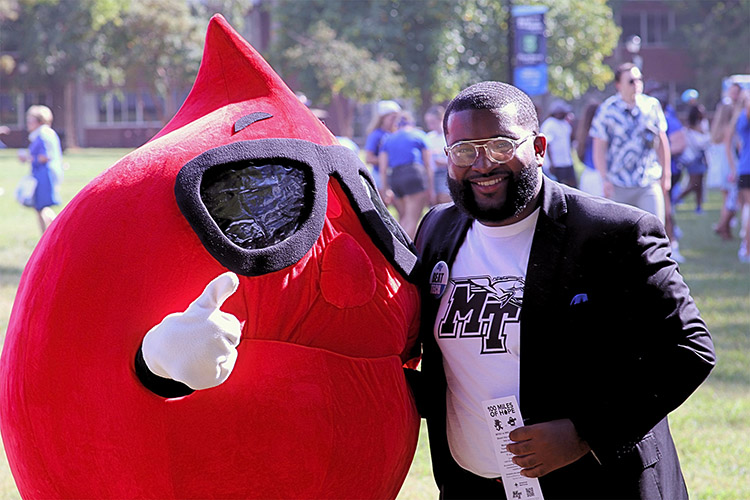 American Red Cross mascot Buddy Blood Drop poses with Michai Mosby, Middle Tennessee State University Student Government Association president, to promote the “100 Miles of Hope” blood drive competition between MTSU and Western Kentucky University at the tailgate in Walnut Grove before the MTSU-Tennessee Tech football game on Saturday, Aug. 31, in Murfreesboro, Tenn. (Photo submitted by Zane Johnson)