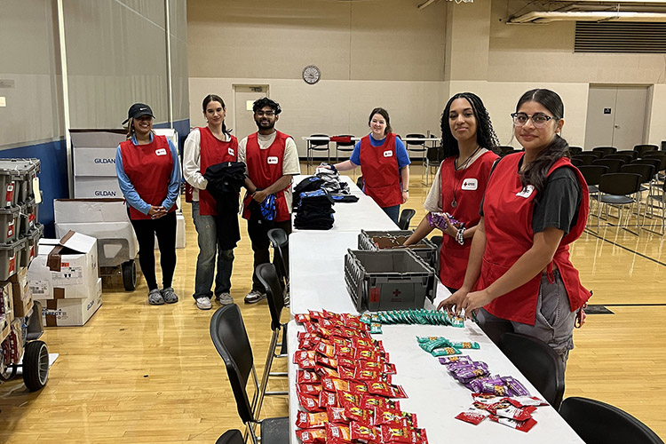 Middle Tennessee State University student blood drive volunteers stand by the free T-shirt and snack incentive table for the “100 Miles of Hope” blood drive competition on Wednesday, Sept. 11, the last day of the drive, in the MTSU Campus Recreation Center gymnasium in Murfreesboro, Tenn. MTSU beat Western Kentucky University by collecting 405 units while WKU collected 369 units. (Photo submitted by Ray Wiley)