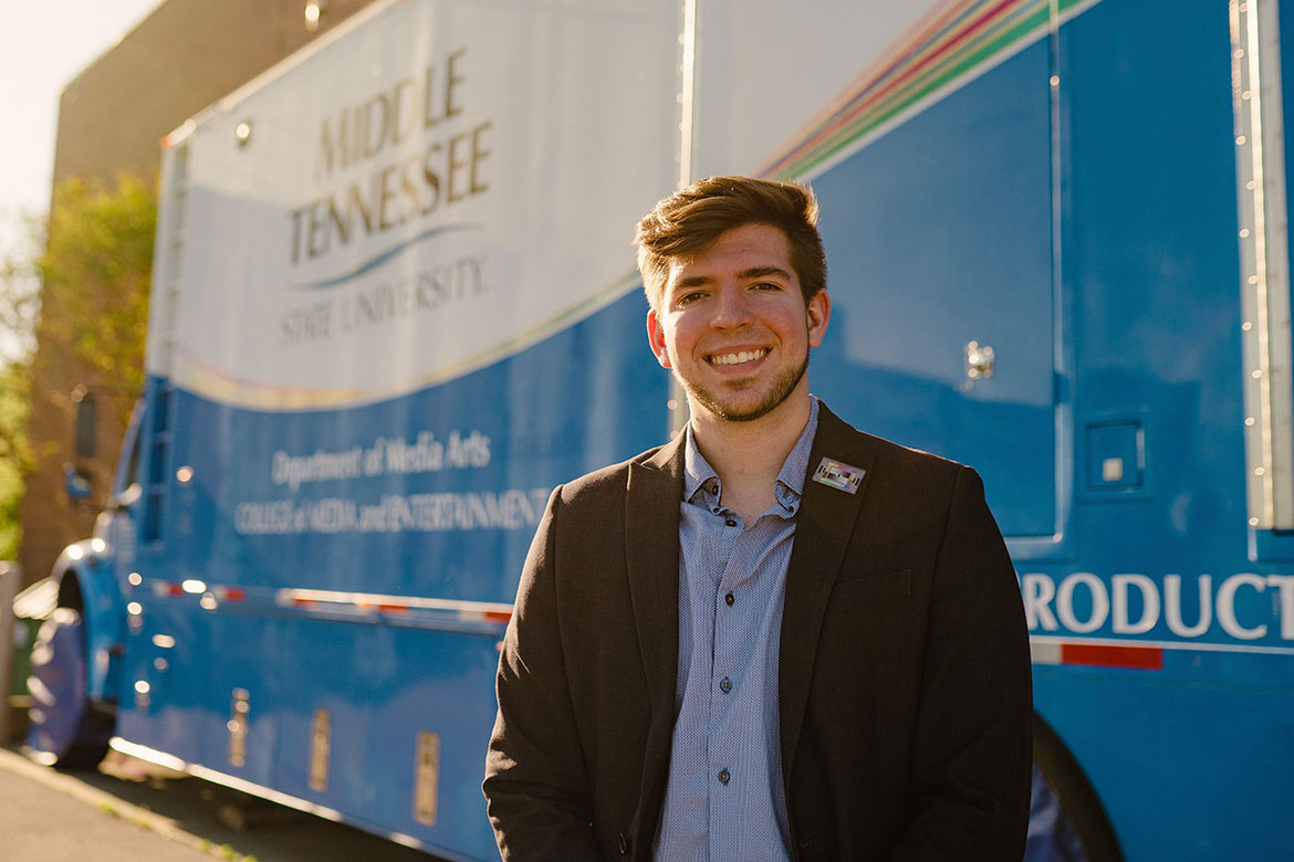 Justin Tart, a 2023 video and film production alum, poses for his senior photos in front of Middle Tennessee State University’s mobile production lab, commonly referred to as “The Truck.” (Photo submitted)