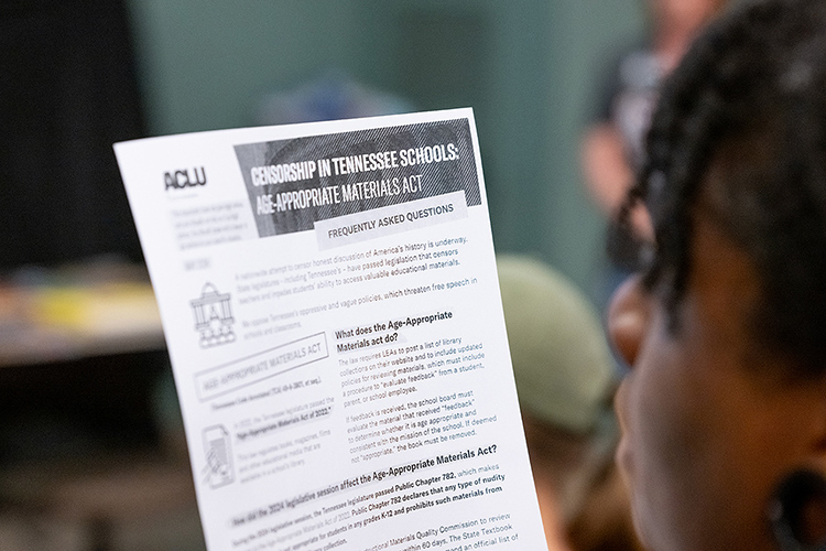 An attendee reads a handout about the state’s Age-Appropriate Materials Act during the “Let Freedom READ” book banning awareness event held Wednesday, Sep. 25, at the College of Education Building on the Middle Tennessee State University campus in Murfreesboro, Tenn. (MTSU photo by Cat Curtis Murphy)