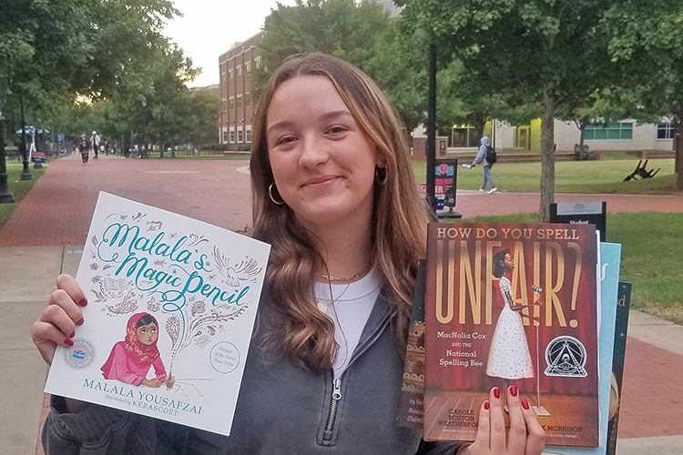 Elly Casteel, a 20-year-old elementary education major from Columbia, Tenn., holds some of the books she picked up at the “Let Freedom READ” book banning awareness event held Wednesday, Sep. 25, at the College of Education Building on the Middle Tennessee State University campus in Murfreesboro, Tenn. (MTSU photo by Amari Henderson)