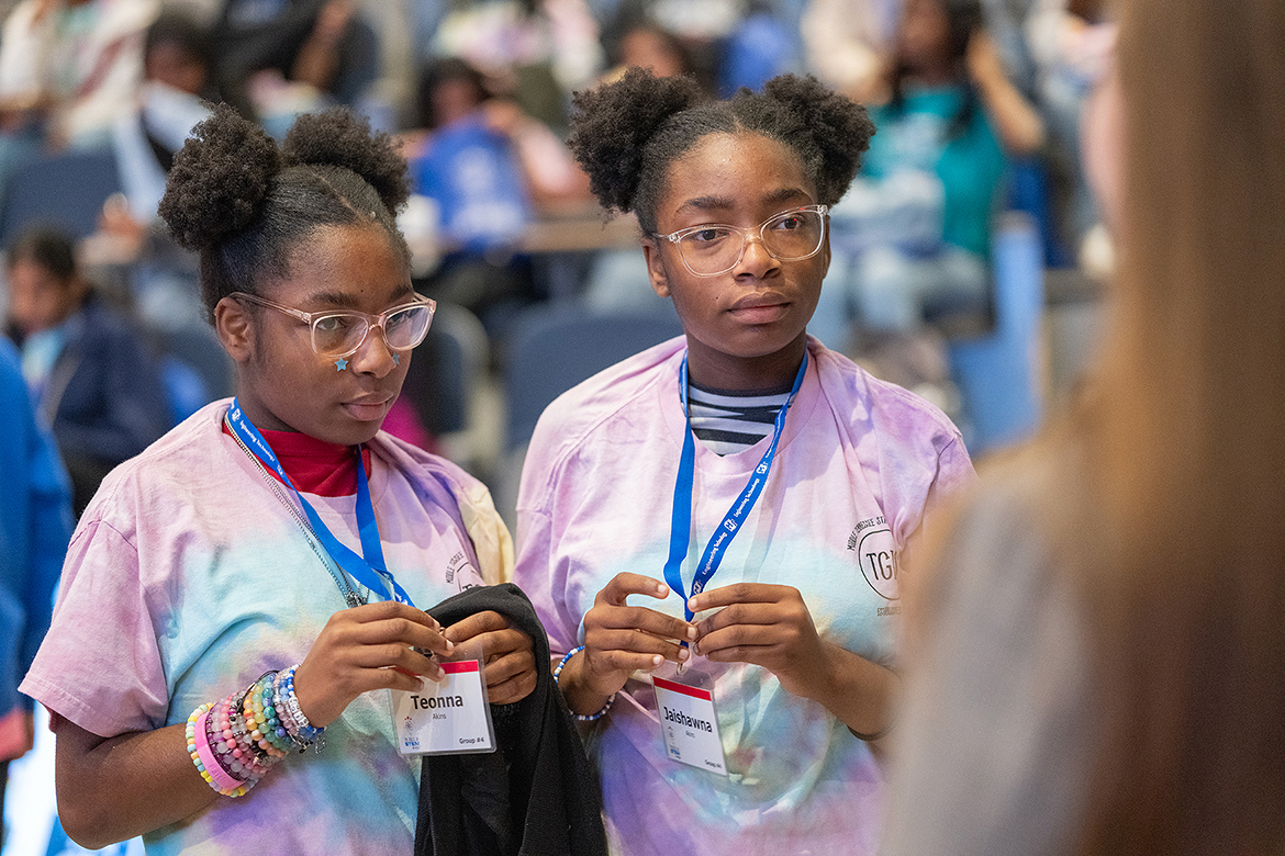 Twins Jaishawna, left, and Teona Akins of Murfreesboro, Tenn., who are freshmen at Siegel High School in Murfreesboro, listen while meeting and talking to Emily Oppmann of Washington, D.C., a Middle Tennessee State University alumna who works in genetic counseling for Inova. (MTSU photo by Cat Curtis Murphy)