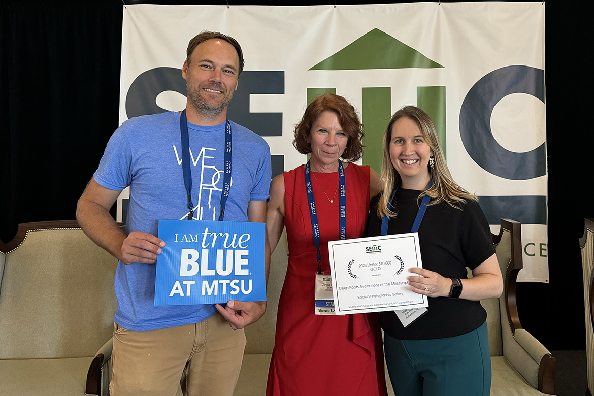 Baldwin Photographic Gallery at Middle Tennessee State University in Murfreesboro, Tenn., was awarded the Gold Prize at the 2024 Southeastern Museums Conference Competition for the exhibit, “Deep Roots: Evocations of the Mississippi Blues,” displayed in fall 2023. Southeastern Museums Conference Director Zinnia Willits, center, presents the Gold Prize to associate professor of photography Shannon Randol, left, and School of Journalism and Strategic Media assistant professor Andrea Hall at the annual meeting held in October in Baton Rouge, La. (Submitted photo)