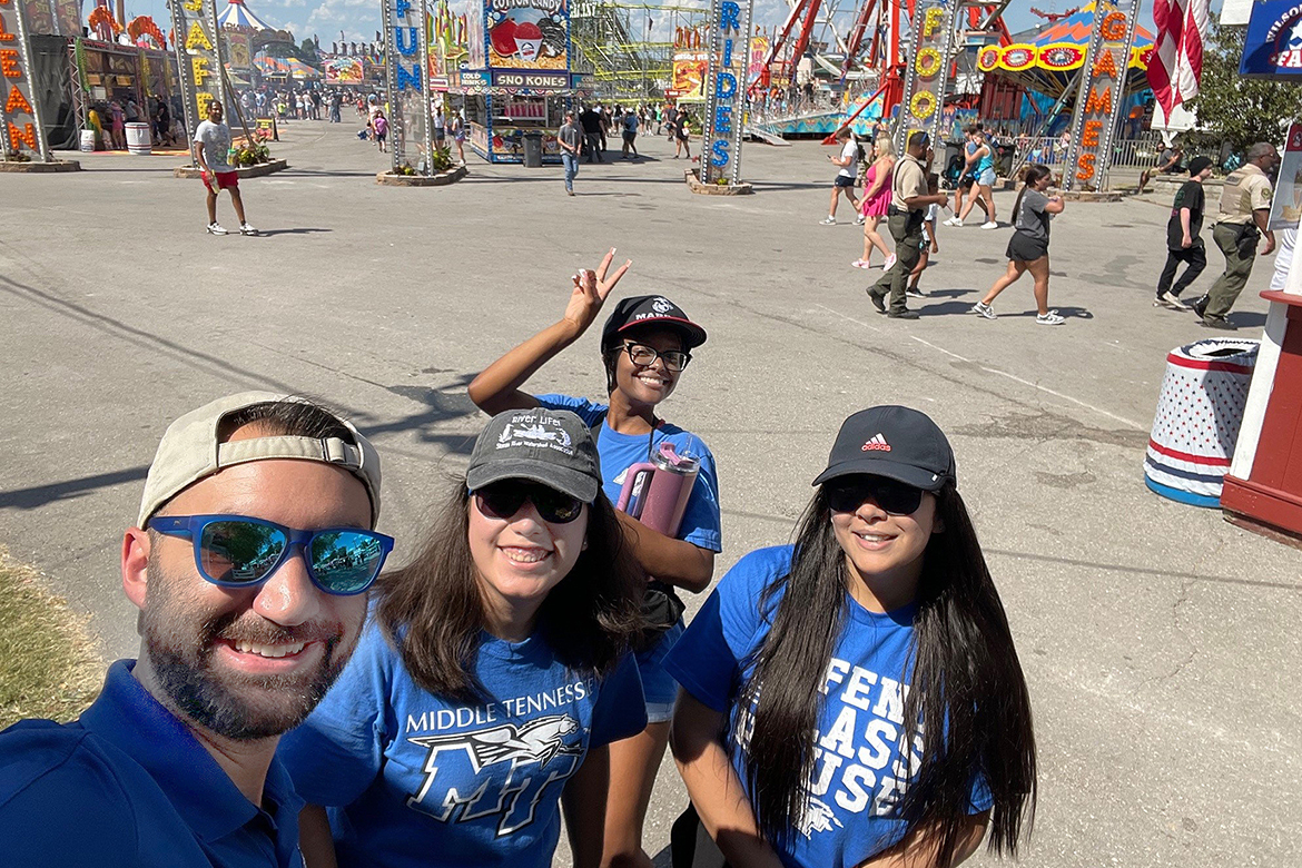 From left, Kahler Stone, associate professor of public health at Middle Tennessee State University in Murfreesboro, Tenn., poses with MTSU public health students, Anakarina Lorenzana-DeWitt, Xaviera Gladden and .Pragya at the Wilson County Fair-Tennessee State Fair in Lebanon, Tenn., in August during a project that collected data from the public about their thoughts and perceptions regarding individuals who struggle with addiction. (Submitted photo)