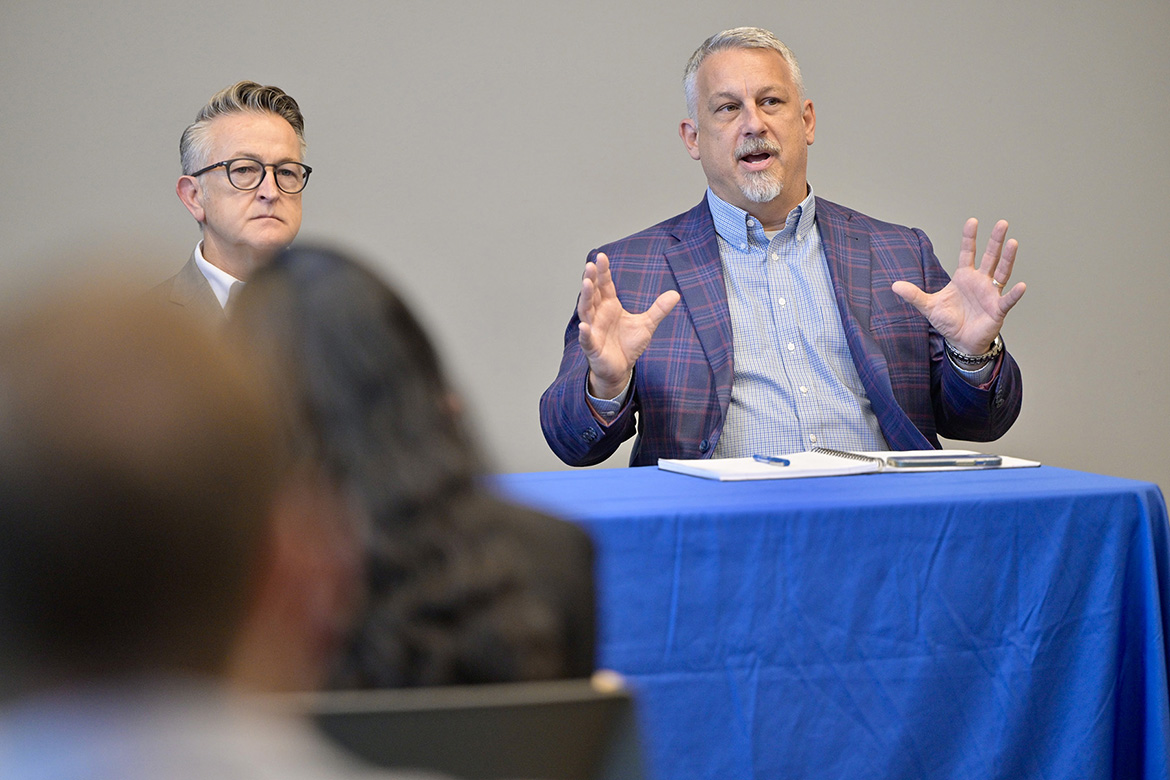 Andy Lucyshyn, right, owner and mid-south region leader with design firm Gresham Smith in Nashville, Tenn., explains his perspectives on sustainability, mobility and livability to Middle Tennessee State University Jennings and Rebecca Jones Chair of Excellence in Urban and Regional Planning Scholars Program students, faculty and staff at the panel discussion on Oct. 25 at the MTSU School of Concrete and Construction Management Building in Murfreesboro. At left is fellow panelist Alan Thompson, chief marketing officer at civil engineering firm RaganSmith in Nashville. (MTSU photo by Andy Heidt)