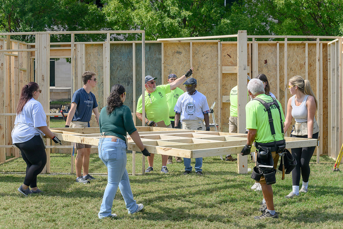 Middle Tennessee State University students and Exit Realty volunteers move parts of a house for the yearly Habitat for Humanity panel build on Thursday, Oct. 3, in the Student Union Commons in Murfreesboro, Tenn. (MTSU photo by J. Intintoli)