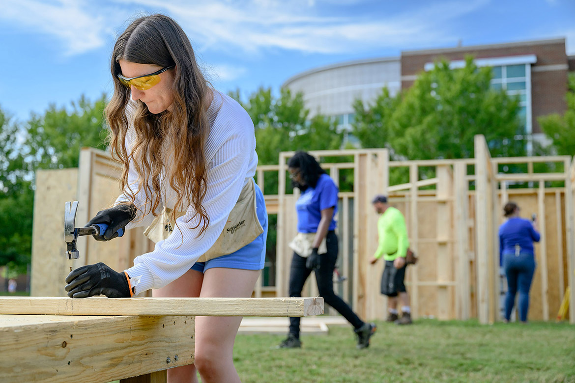 A Middle Tennessee State University student hammers a nail to continue building a house for the annual Habitat for Humanity panel build on Thursday, Oct. 3, in the Student Union Commons in Murfreesboro, Tenn. (MTSU photo by J. Intintoli)