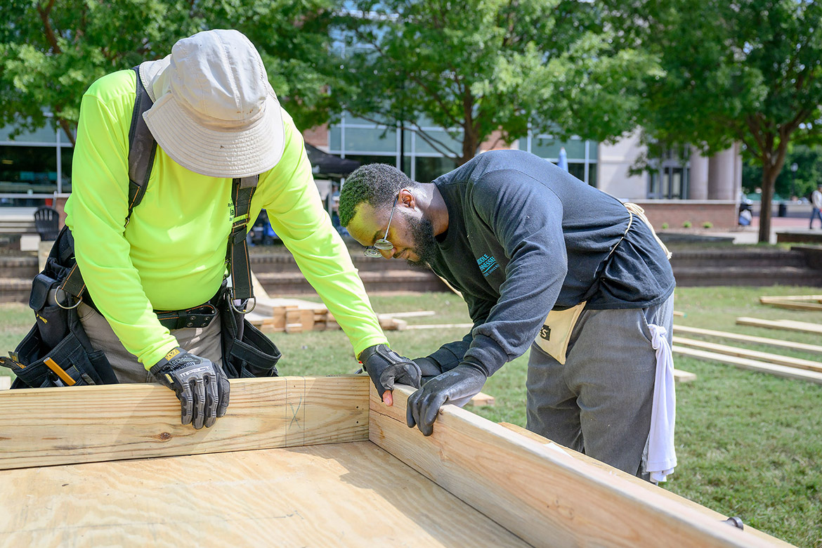 A Middle Tennessee State University student works alongside an Exit Realty volunteer at the annual Habitat for Humanity panel build on Thursday, Oct. 3, in the Student Union Commons in Murfreesboro, Tenn. (MTSU photo by J. Intintoli)