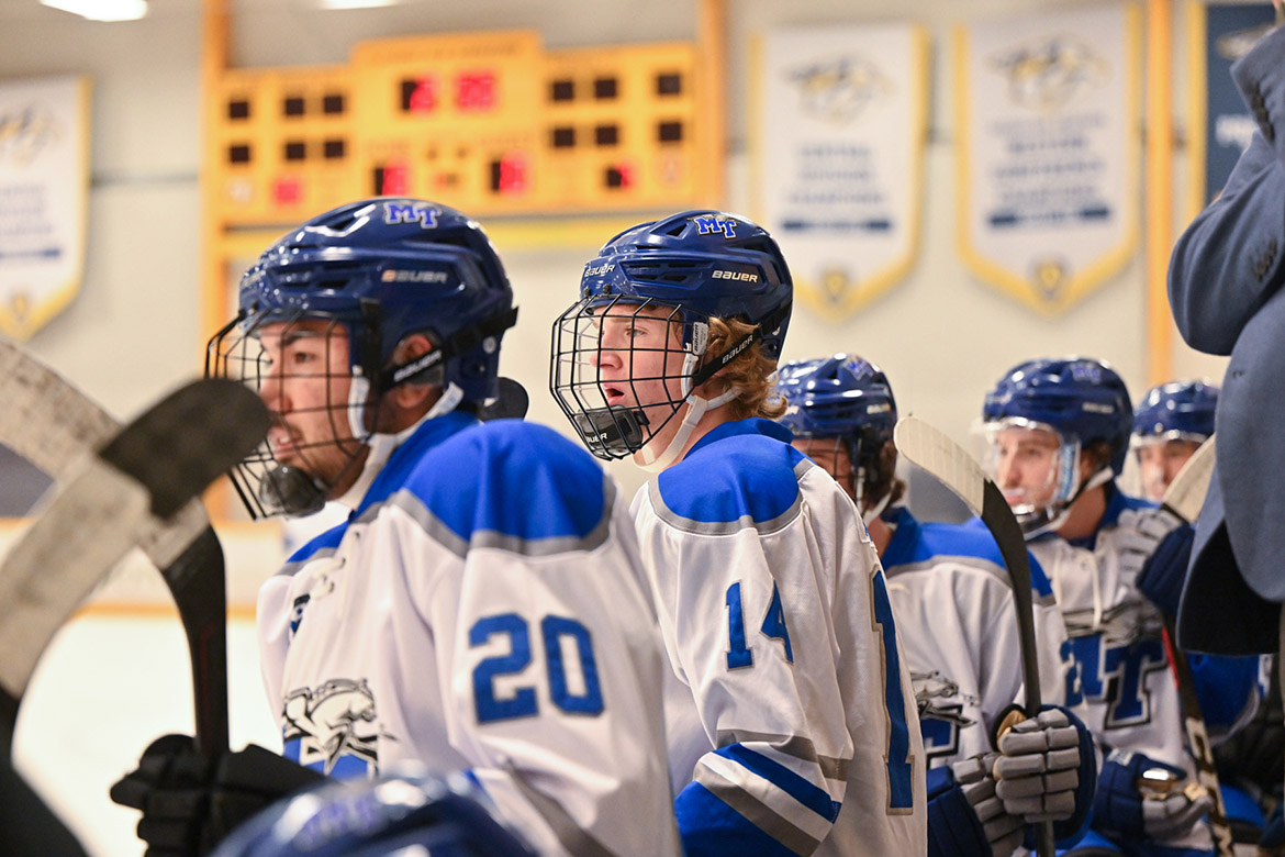 Middle Tennessee State University’s ice hockey players watch their teammates from the sidelines as they prepare to play at the first home game against the University of Alabama-Birmingham on Sept. 27 at the Ford Ice Center in Antioch, Tenn. From left, the first two players are Garon Hendricks, a junior from Murfreesboro, Tenn., and Jackson Crawford, a sophomore from Nashville, Tenn. Both are wingers for MTSU’s ice hockey team. (MTSU photo by James Cessna)