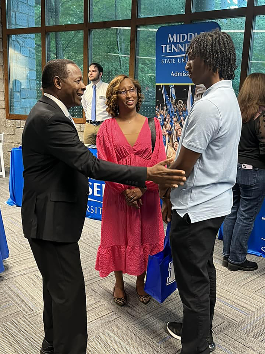 President Sidney A. McPhee, left, meets Inga Clark of Canton, Ga., and her son, Justin Clark, who is interested in MTSU’s video and film production in the College of Media and Entertainment and has applied for a Buchanan Fellowship with the Honors College. The interaction occurred Monday, Oct. 21, at the Atlanta Zoo in Atlanta, Ga., as part of the MTSU True Blue Tour. (MTSU photo by James Cessna)