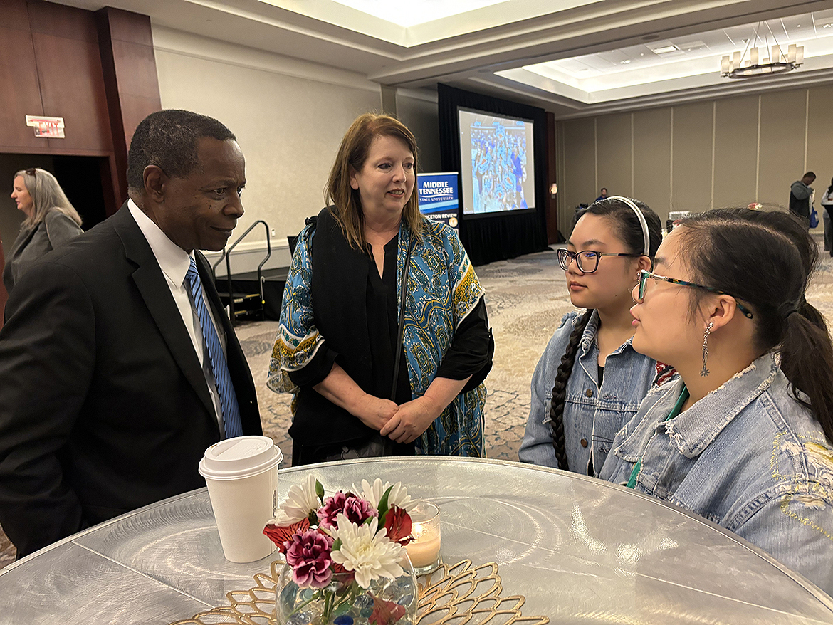 During the True Blue Tour recruiting event Thursday, Oct. 17, at The Westing Huntsville in Huntsville, Ala., Middle Tennessee State University President Sidney A. McPhee, left, listens while Maxine Beasley, right, 16, of Athens, Ala., and Shelbyville, Tenn., discusses her interest in wanting to attend the university starting in fall 2025. Listening to their conversation are her mother, Beth Beasley, and twin sister BiBi Beasley. (MTSU photo by Randy Weiler)