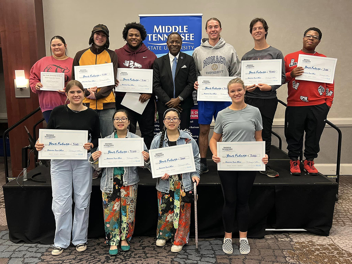 Ten recipients of $3,000 Middle Tennessee State University scholarships are shown with MTSU President Sidney A. McPhee, second row center, during the Thursday, Oct. 17 True Blue tour recruiting event at The Westin Huntsville in Huntsville, Ala. Huntsville-area students expressed an interest in a variety of  MTSU programs including animation, animal science, business and more. (MTSU photo by Andrew Oppmann)