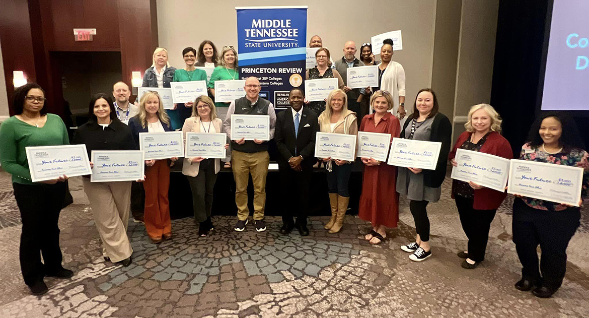 More than 20 Huntsville, Ala.-area counselors and community college staff left the Middle Tennessee State University True Blue Tour recruiting event Thursday, Oct. 17, at The Westin Huntsville in Huntsville, Ala., with $3,000 scholarship they can award to their students. They are shown with MTSU President Sidney A. McPhee, first row center. (MTSU photo by Andrew Oppmann)