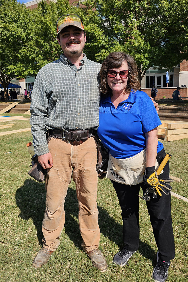 Davis Dunlap, a 2023 Middle Tennessee State University construction management alumnus, left, poses with Dianna Rust, university studies professor, at the annual Habitat for Humanity panel build on Thursday, Oct. 3, in the Student Union Commons in Murfreesboro, Tenn. Dunlap was a former honors student of Rust and now works for Habitat for Humanity. (Photo submitted)