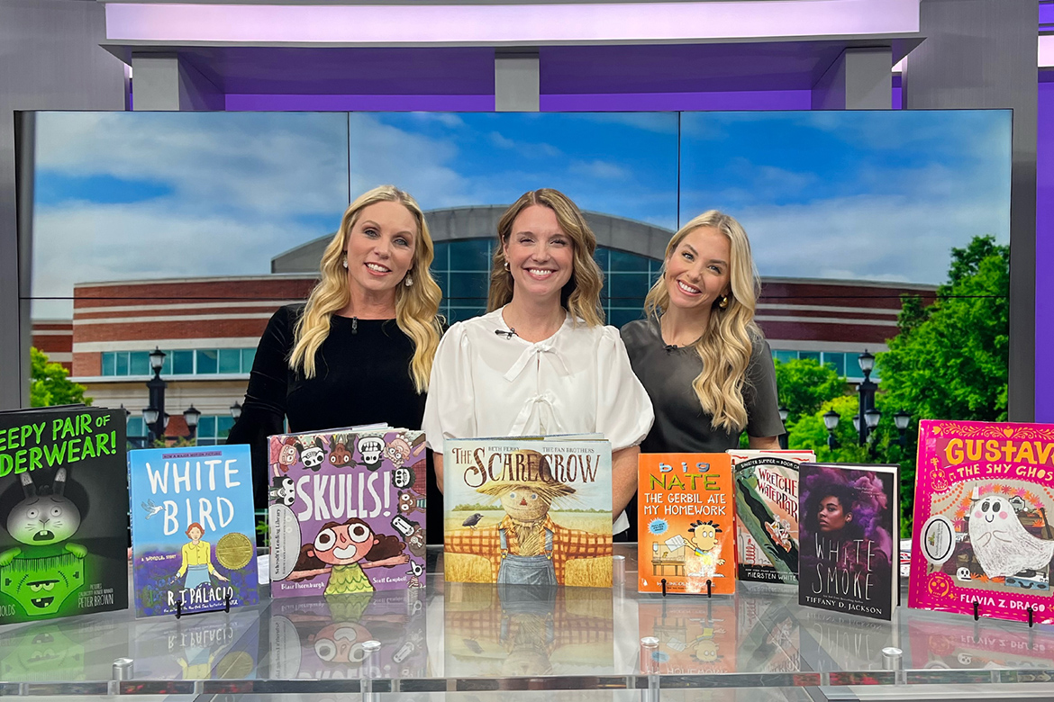 Katie Schrodt, center, an associate professor in Middle Tennessee State University's College of Education, is shown with a collection of books she recommends parents read with or get for their children this fall during her appearance on the “MTSU on 2” segment on WKRN-TV News 2’s Local on 2 programming, broadcast from the station’s Nashville studio. Shown with her are program co-hosts Stephanie Langston, an MTSU alumna, and co-hosts Laura Schweizer. (MTSU photo by Kristen Keene)