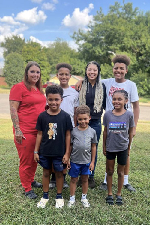 Future Habitat for Humanity homeowner Kelly poses with her six children. She and her children will eventually move into a new house partially built by Middle Tennessee State University students, faculty and staff and Exit Realty volunteers on Thursday, Oct. 3, in the MTSU Student Union Commons in Murfreesboro, Tenn. (Photo courtesy of Rutherford County Area Habitat for Humanity)