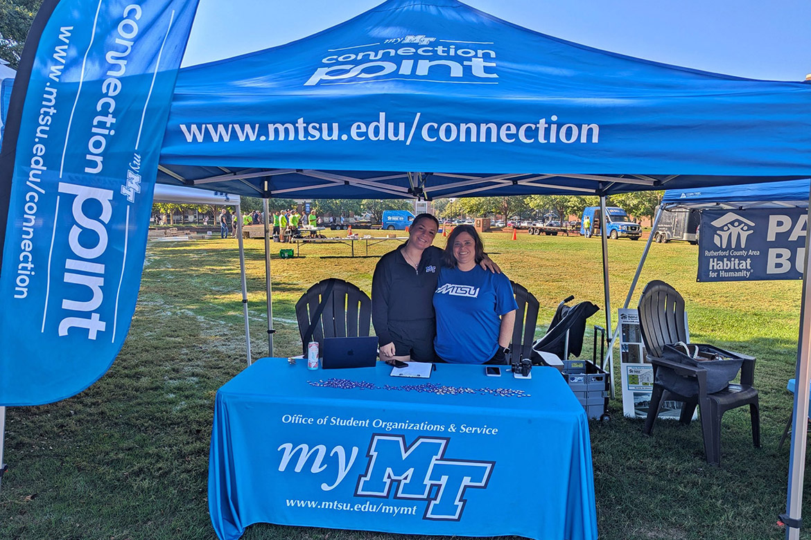 Jackie Victory, right, director of Middle Tennessee State University’s Student Organizations and Service, and graduate assistant Alayna Hurst staff the Connection Point check-in table at the Habitat for Humanity panel build on Thursday, Oct. 3, in the Student Union Commons in Murfreesboro, Tenn. The event drew a host of student, faculty, staff and Exit Realty volunteers. (Photo courtesy of Rutherford County Area Habitat for Humanity)