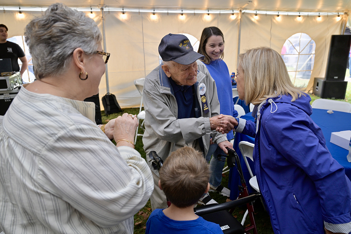 A group of well-wishers greet U.S. Navy veteran Bill Allen, 99, center, of Murfreesboro, Tenn., following him receiving the annual Joe Nunley Sr. Award for service Saturday, Nov. 9, during the Middle Tennessee State University veterans picnic, part of the 42nd annual Salute to Veterans and Armed Forces game activities honoring vets and active-duty personnel. (MTSU photo by Andy Heidt)