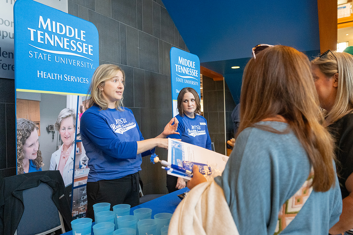 Melissa Taylor, left, director of nursing and clinical services in the Middle Tennessee State University Health Services Department, and nurse Amanda Scales talk with a prospective MTSU student and her mother about offerings available to students during the Nov. 4 True Blue Preview day in the Student Union on the MTSU campus in Murfreesboro, Tenn. Prospective students must apply by Sunday, Dec. 1, to receive a guaranteed scholarship for the 2025-26 academic year. (MTSU photo by Cat Curtis Murphy)