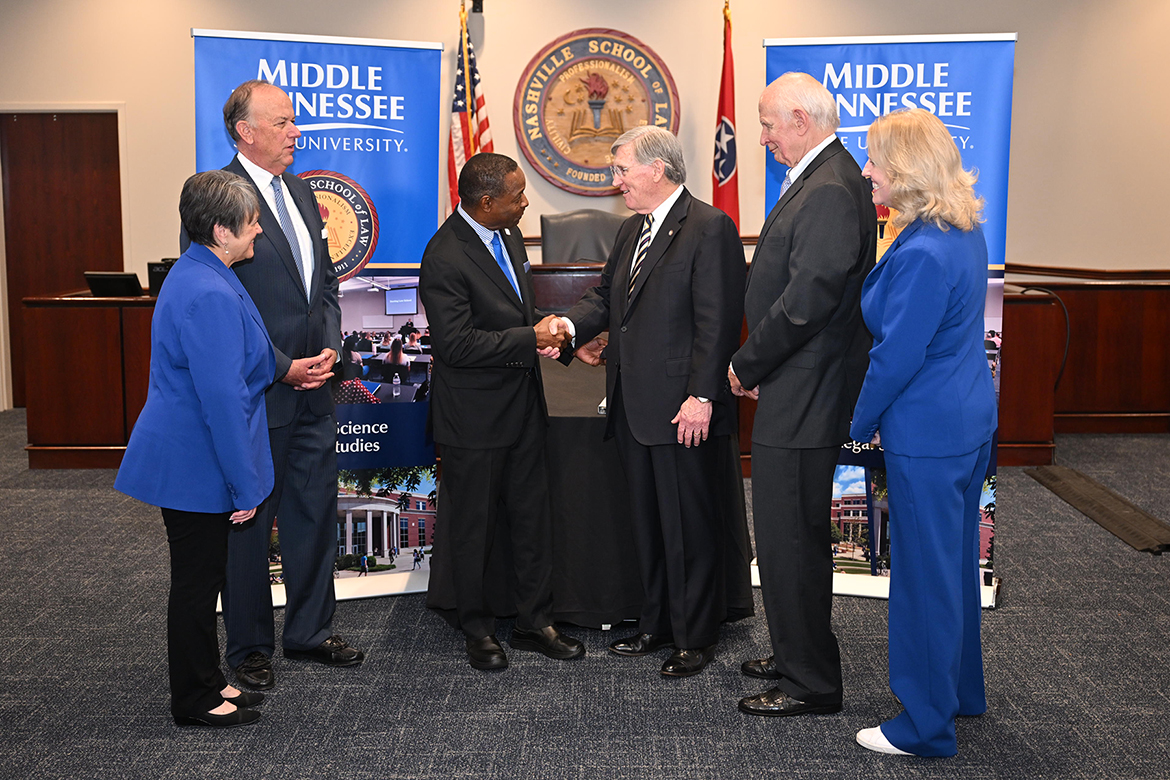 Middle Tennessee State University President Sidney A. McPhee, center left, shakes hands with Nashville School of Law Dean William C. Koch Jr. following the institutions’ joint announcement Tuesday, Nov. 19, on the NSL campus in Nashville, Tenn., outlining a partnership in which a new MTSU master’s degree in legal studies will be taught in part by NSL faculty. Pictured, from left, are Joyce Heames, dean of MTSU’s Jones College of Business; Stephen Smith, MTSU Board of Trustees chairman; McPhee; Koch; Nashville attorney Aubrey Harwell Jr., chair of the NSL Board of Trust; and Beverly Keel, dean of MTSU’s College of Media and Entertainment. (MTSU photo by James Cessna)