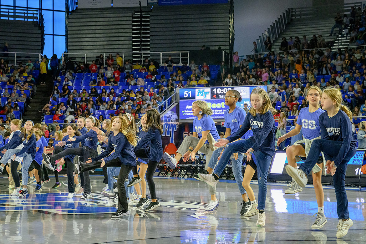 Homer Pittard Campus School students and choir members perform a physical activity during halftime of the Middle Tennessee State University men’s basketball game between the Blue Raiders and visiting Oglethorpe University from Atlanta, Georgia, in the annual Rutherford County Schools’ Education Day game in Murphy Center on the MTSU campus in Murfreesboro, Tenn., on Monday, Nov. 4.  (MTSU photo by J. Intintoli) Students from all RCS elementary schools and the RCS Transition Academy were treated to a men's basketball game to expose them to the university campus.