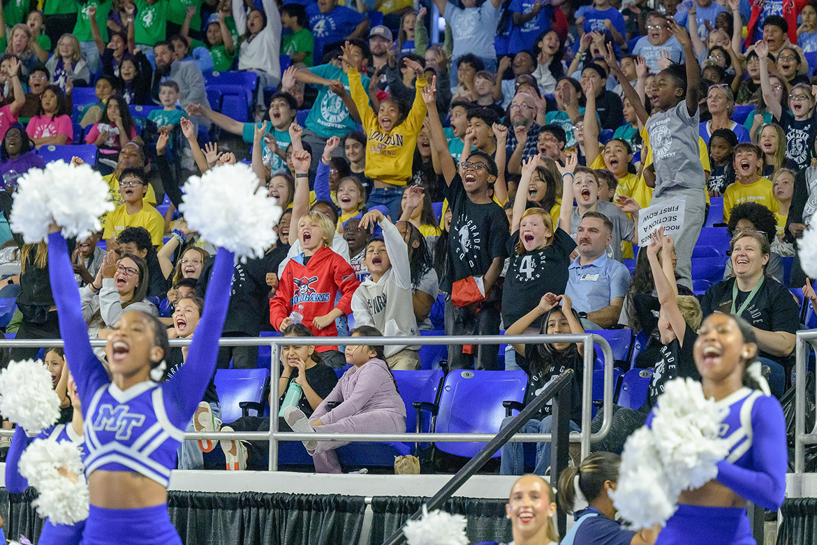 With Middle Tennessee State University cheerleaders’ assistance on the court, Rock Springs Elementary School students cheer on the Blue Raider men’s basketball team, who defeated the visiting Oglethorpe University Petrels 97-51 in the annual Rutherford County Schools’ Education Day game in Murphy Center on the MTSU campus. (MTSU photo by J. Intintoli)