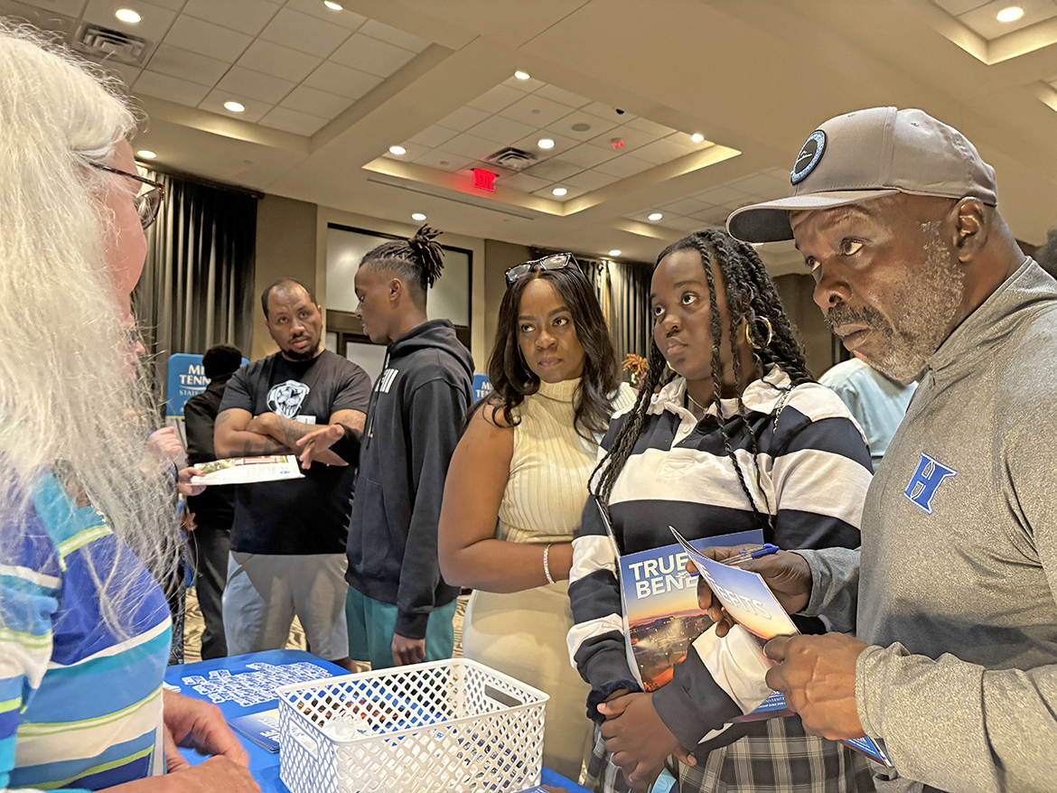 Nikki Hunter, second from left, daughter Rhegan Hunter, a senior at Harding Academy, and Robb Hunter of Memphis, Tenn., listen intently as Julie Baker, MT One Stop Enrollment Coordinator II, explains financial aid, scholarship and admissions information during the Middle Tennessee State University True Blue Tour recruiting event Oct. 28 at Esplande Memphis in Cordova, Tenn. (MTSU photo by Randy Weiler)