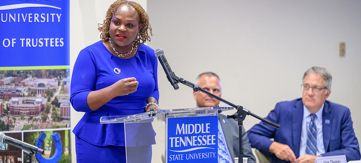 With Vice President of Business and Finance Alan Thomas, second from left, and Provost Mark Byrnes looking on, Khalilah Doss, left, addresses members of the Middle Tennessee State University Board of Trustees in early June following her appointment as vice president of student affairs and dean of students during their meeting at the Miller Education Center on Bell Street in Murfreesboro, Tenn. Doss, a Kingston, Jamaica, native who came to MTSU from the University of Southern Indiana in Evansville, was recommended to the board by university President Sidney A. McPhee. (MTSU photo by J. Intintoli)