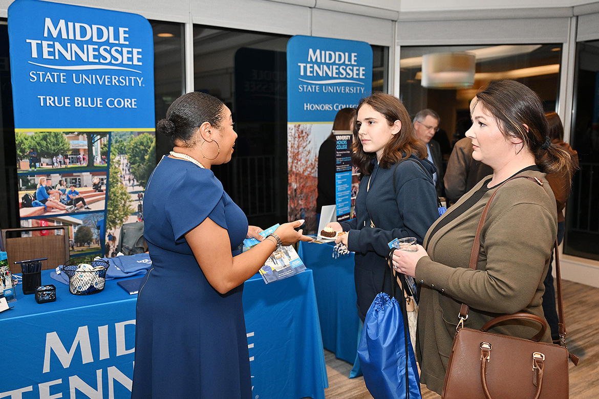 Christina Cobb, implementation coordinator of True Blue Core at Middle Tennessee State University in Murfreesboro, Tenn., explains details about core curriculum requirements to a Nashville, Tenn.-area high schooler and parent during a True Blue Tour recruitment event held Thursday, Nov. 7, at Gaylord Springs Golf Links club in Nashville, Tenn. (MTSU photo by James Cessna)