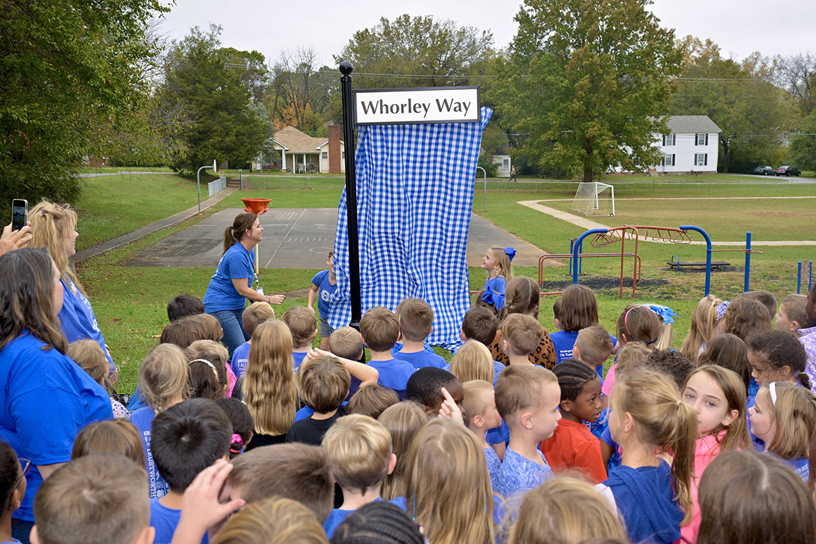 Homer Pittard Campus School first grade students unveil the “Whorley Way” street sign near Burton Street, one of the school’s entrances, to honor former principal and first grade teacher Liz Whorley Bradley in Murfreesboro Tenn. Middle Tennessee State University partnered with Friends of Campus School and Rutherford County Schools to plan and implement the street signs. (MTSU photo by Andy Heidt)