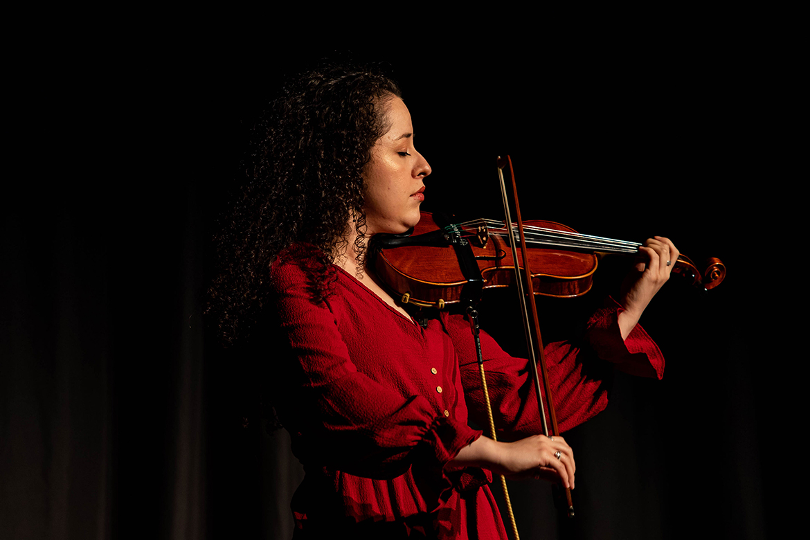 Violinist and Middle Tennessee State University graduate student Inti Jiménez Copete performs live Dec. 12 inside the Student Union Ballroom, enhancing the immersive experience during the premiere of the animated film “All One,” which was created, produced and directed by College of Media and Entertainment students. (Photo by MTSU student Cynthia Maravilla)