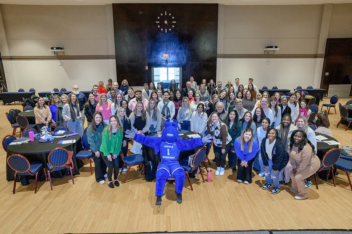 Middle Tennessee State University’s mascot Lightning poses with College of Education students at the Dec. 12 seminar, which celebrates students who completed their semester-long student teaching residencies, in the James Union Building on campus in Murfreesboro, Tenn. At this event, Middle Tennessee Electric awarded the college $40,000 to outfit future teacher classrooms each semester for the next four years, and two students received $2,500 Spark Awards to decorate their classrooms. (MTSU photo by J. Intintoli)