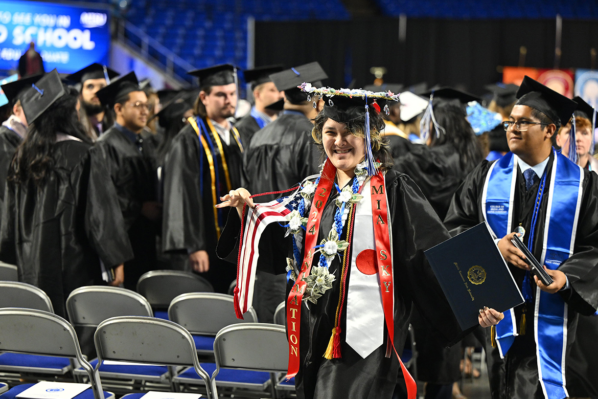 Middle Tennessee State University animation major Mia Sky shows off colorful adornments on her graduation gown after walking off stage with her diploma during the afternoon commencement ceremony held for the fall graduating Class of 2024 on Saturday, Dec. 14, inside Murphy Center on campus in Murfreesboro, Tenn. MTSU presented nearly 1,600 degrees to undergrad and graduate students during morning and afternoon ceremonies. (MTSU photo by Andy Heidt)