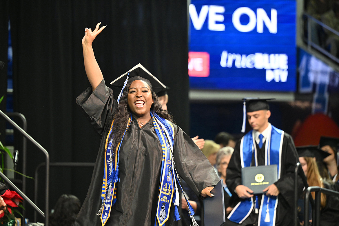 A member of Middle Tennessee State University’s fall Class of 2024 holds up her new degree as she heads back to her seat during the morning commencement ceremony held Saturday, Dec. 14, inside Murphy Center on campus in Murfreesboro, Tenn. MTSU presented nearly 1,600 degrees to undergrad and graduate students during morning and afternoon ceremonies. (MTSU photo by Cat Curtis Murphy)