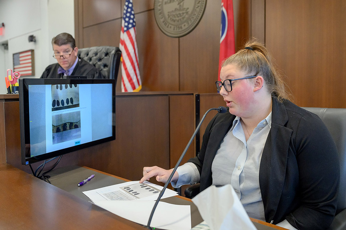 Rebecca Taylor, a senior forensic science major at Middle Tennessee State University in Murfreesboro, Tenn., explains details about fingerprints in a court case she created for her senior seminar during a mock trial she participated in as a class project while Circuit Court Judge Barry Tidwell listens. (MTSU photo by J. Intintoli)