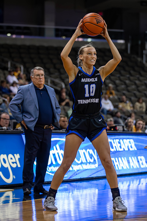 With head coach Rick Insell, left, looking on, Middle Tennessee State University women’s basketball player Jalynn Gregory looks to make a pass in this undated photo from a Blue Raider women’s game inside Murphy Center in Murfreesboro, Tenn. (Courtesy of MTSU Athletics)