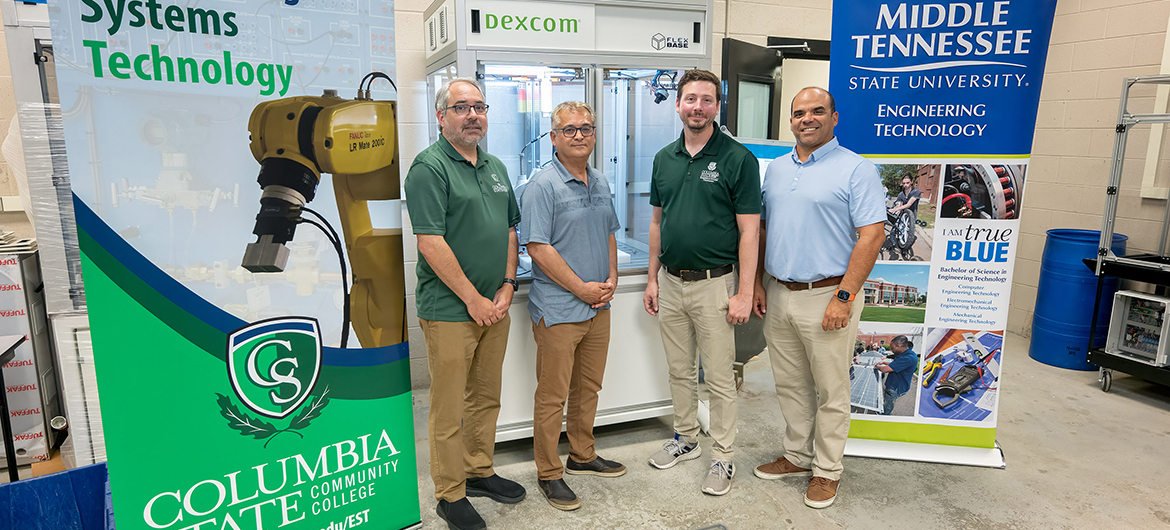 From left, Columbia State Community College Development Officer (development and grants) Patrick McElhiney, Business and Technology Dean Mehran Mostajir and adjunct faculty member Daniel Garrett and Middle Tennessee State University Engineering Technology associate professor Jorge Vargas celebrate the National Science Foundation grant partnership that will assist the Midstate region in certifying future technicians in robotics and automation systems in a classroom lab on the MTSU campus in Murfreesboro, Tenn., earlier this year. The nearly $350,000 NSF is a three-year research and development award that continues until May 31, 2027, and could bring Columbia State graduates to MTSU. (MTSU photo by Andy Heidt)