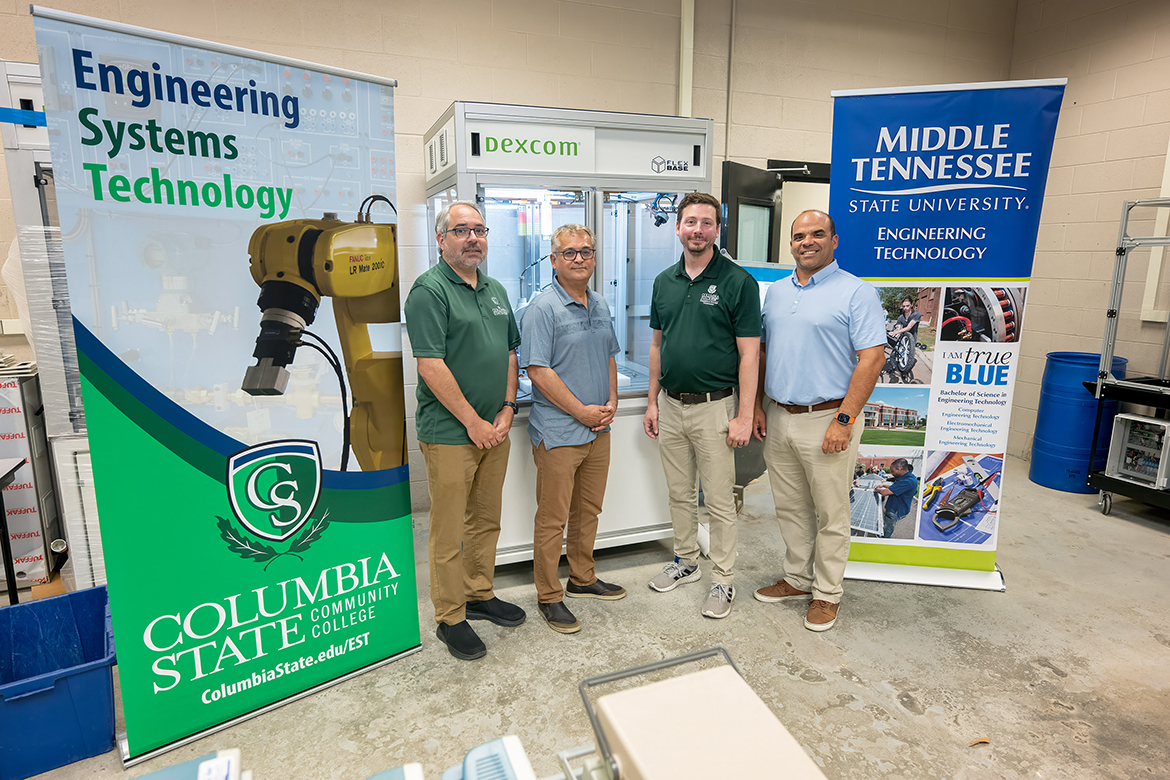 From left, Columbia State Community College Development Officer (development and grants) Patrick McElhiney, Business and Technology Dean Mehran Mostajir and adjunct faculty member Daniel Garrett and Middle Tennessee State University Engineering Technology associate professor Jorge Vargas celebrate the National Science Foundation grant partnership that will assist the Midstate region in certifying future technicians in robotics and automation systems in a classroom lab on the MTSU campus in Murfreesboro, Tenn., earlier this year. The nearly $350,000 NSF is a three-year research and development award that continues until May 31, 2027, and could bring Columbia State graduates to MTSU. (MTSU photo by Andy Heidt)