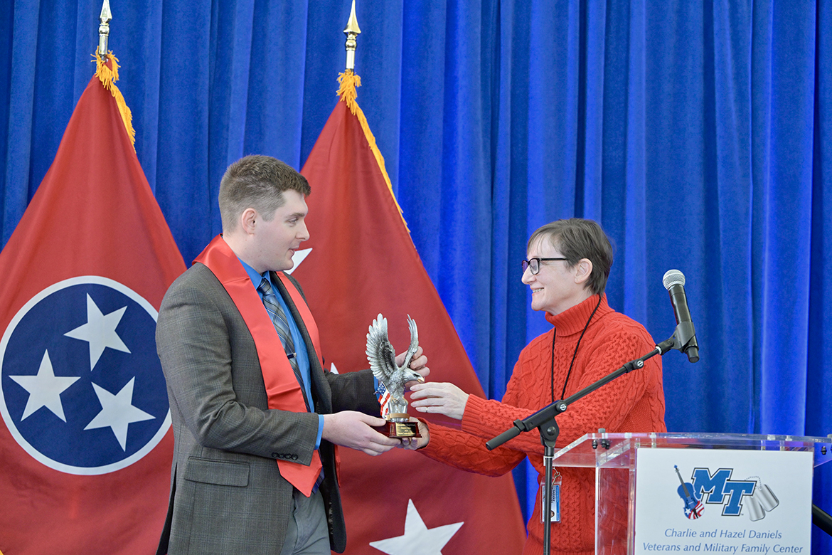 Alexander Hagerman, left, of Nashville, Tenn., a Middle Tennessee State University graduating senior cadet in the Department of Military Science ROTC program, receives the Veteran Leadership Award from Laurie Witherow, MTSU vice provost for enrollment management, Thursday, Dec. 12, during the Graduating Veterans Stole Ceremony at the Miller Education Center on Bell Street in Murfreesboro, Tenn. Hagerman, who will graduate Saturday, Dec. 14, with a bachelor’s in business administration in ceremonies in Murphy Center, was commissioned as a second lieutenant Friday, Dec. 12, in a ceremony in the Tom H. Jackson Building’s Cantrell Hall. (MTSU photo by Andy Heidt)