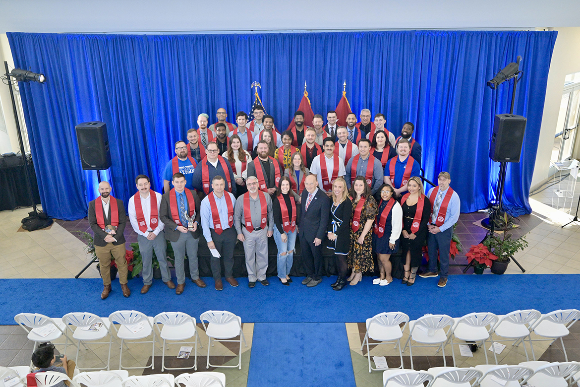 Nearly 40 Middle Tennessee State University seniors attending the Graduating Veterans Stole Ceremony gather for a group photo following the fall Graduating Veterans Stole Ceremony, held Thursday, Dec. 12, at the Miller Education Center on Bell Street in Murfreesboro, Tenn. Nearly 70 veterans will graduate Saturday, Dec. 14, in ceremonies at Murphy Center. (MTSU photo by Andy Heidt)