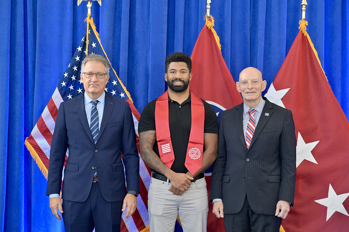 Jamere Morrison, center, of Spring Hill, Tenn., receives congratulations from Middle Tennessee State University Provost Mark Byrnes, left, and Keith M. Huber, MTSU senior adviser for veterans and leadership initiatives and a retired U.S. Army lieutenant general, Thursday, Dec. 12, during the fall Graduating Veterans Stole Ceremony held in the Miller Education Center on Bell Street in Murfreesboro, Tenn. Nearly 40 student veterans attended the ceremony, part of a group of 68 who will graduate Saturday, Dec. 14, in ceremonies in Murphy Center. (MTSU photo by Andy Heidt)