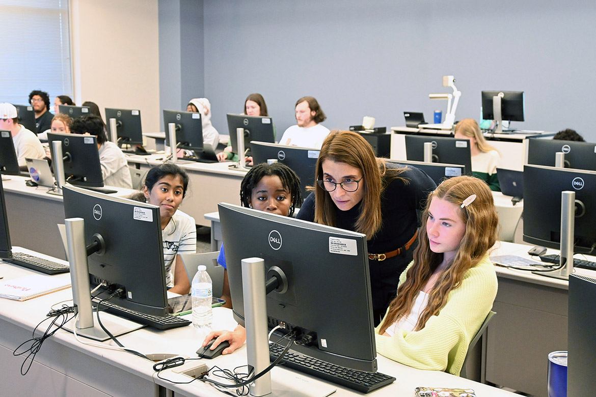 Gaia Rancati, assistant professor of marketing at Middle Tennessee State University in Murfreesboro, Tenn., assists a group of students with their project in her neuromarketing course which uses iMotion Online for Education artificial intelligence, or AI, software in the Business and Aerospace Building. (MTSU photo by Maddy Williams)