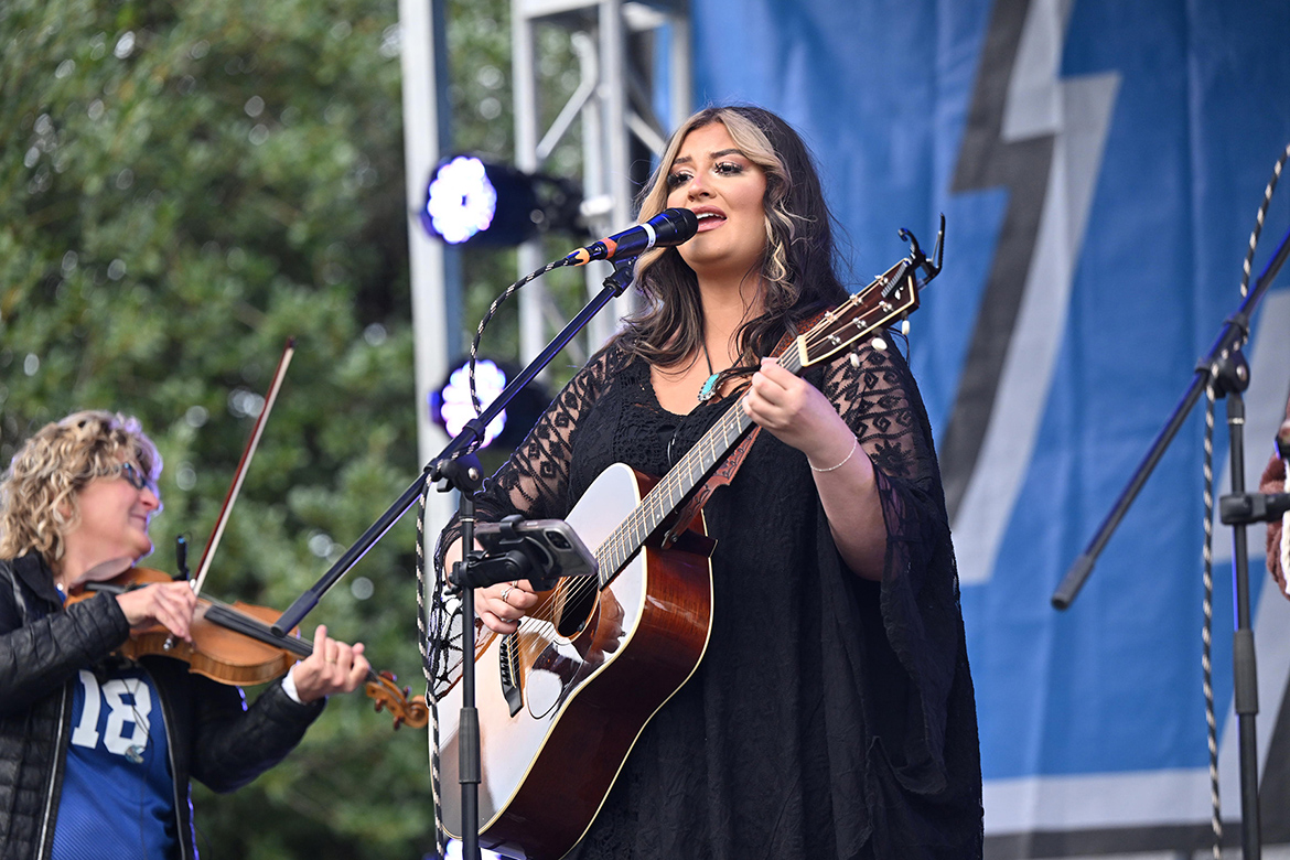 Middle Tennessee State University alumna and rising country artist Hunter Wolkonowski, who performs as HunterGirl, sings a selection for the crowd at the Party in the Grove pregame tailgating event held in the Walnut Grove area before the MTSU Blue Raider football team played Kennesaw State University at nearby Floyd Stadium on campus in Murfreesboro, Tenn. (MTSU file photo by James Cessna)