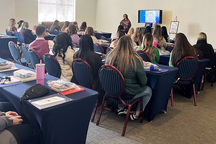 Nearly 30 elementary education fall 2024 graduates from the College of Education at Middle Tennessee State University in Murfreesboro, Tenn., gathered for a presentation from Cassidy Cares: Bookmarked from Heaven, a family project started four years ago in memory of late alumna Cassidy Adair Ganey. The project biannually donates books for MTSU elementary education graduates who are establishing their first classroom. (Submitted photo)