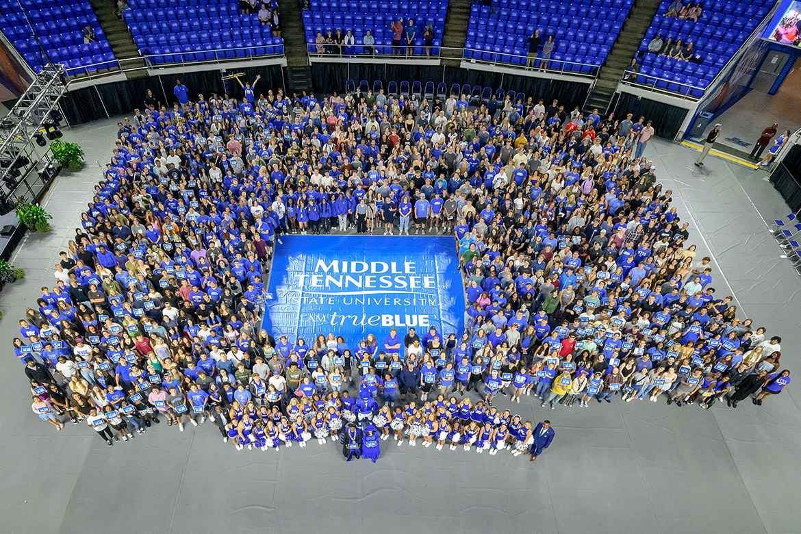 In what has become an annual tradition, Middle Tennessee State University President Sidney A. McPhee, front left, and first lady Elizabeth McPhee, front right, hold up “I Am True Blue” signs for a group photo along with the hundreds of new students who attended the 2025 Convocation ceremony held Saturday, Aug. 23, in Murphy Center on campus in Murfreesboro, Tenn. Convocation officially welcomed the Class of 2029 as well as transfer students to the Blue Raider community. (MTSU photo by J. Intintoli)