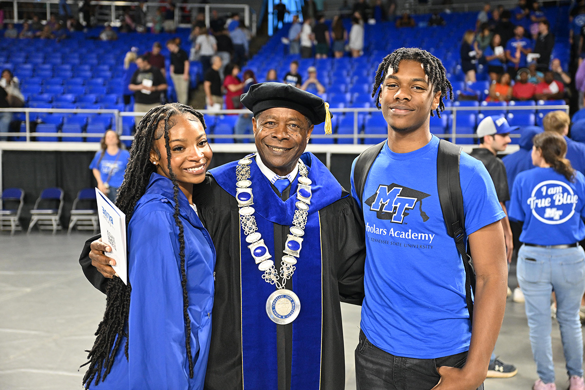 Middle Tennessee State University President Sidney A. McPhee, center, pauses to take a photo with two new students at the 2025 Convocation ceremony held Saturday, Aug. 23, in Murphy Center on campus in Murfreesboro, Tenn. (MTSU photo by James Cessna)