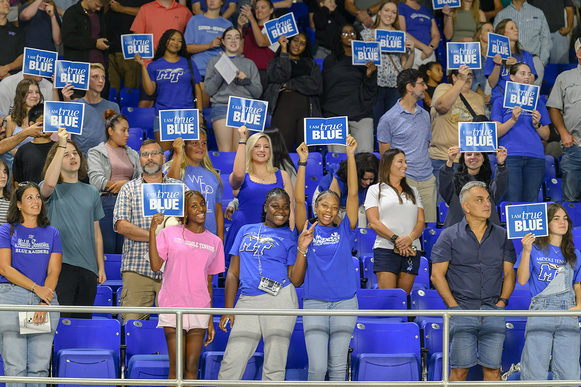 Surrounded by friends and family, new Middle Tennessee State University students hold up “I Am True Blue” signs toward the end of the Convocation ceremony held Saturday, Aug. 23, in Murphy Center on campus in Murfreesboro, Tenn. (MTSU photo by J. Intintoli)
