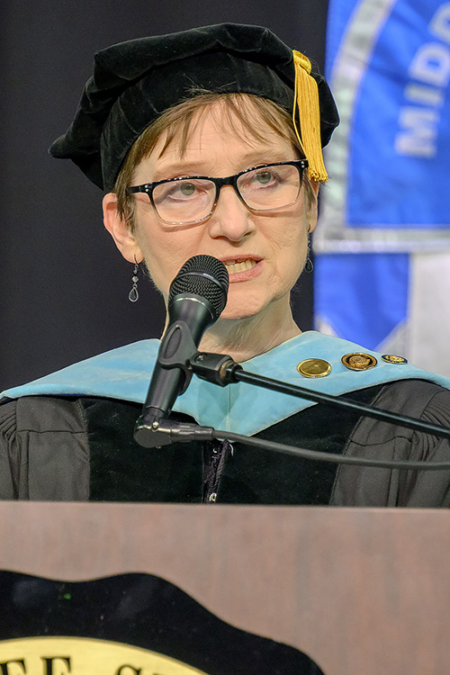 Laurie Witherow, vice provost for Enrollment Management in the Division of Academic Affairs, explains the symbolism surrounding the 2025 Convocation ceremony held Saturday, Aug. 23, in Murphy Center on campus in Murfreesboro, Tenn., to officially welcome new Blue Raider students to the campus community. (MTSU photo by J. Intintoli)