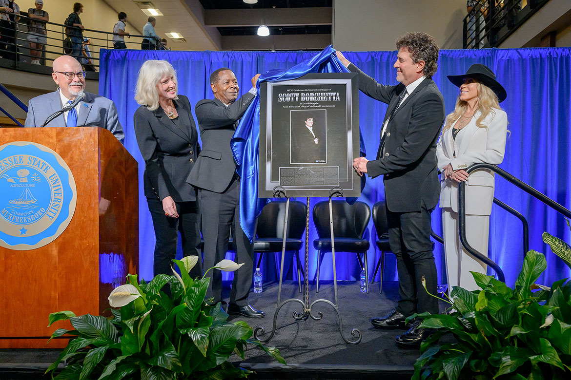 Scott Borchetta, second from right, Big Machine Label Group founder, chairman and CEO, unveils a commemorative sign Tuesday, Aug. 26, during a special ceremony to announce the renaming of Middle Tennessee State University’s media college to the Scott Borchetta College of Media and Entertainment. The announcement was held in the atrium of the John Bragg Building on campus in Murfreesboro, Tenn. Pictured, from left, are Andrew Oppmann, university spokesman and event emcee; Beverly Keel, dean of the college; MTSU President Sidney A. McPhee; Borchetta and his wife, Sandi. (MTSU photo by J. Intintoli)